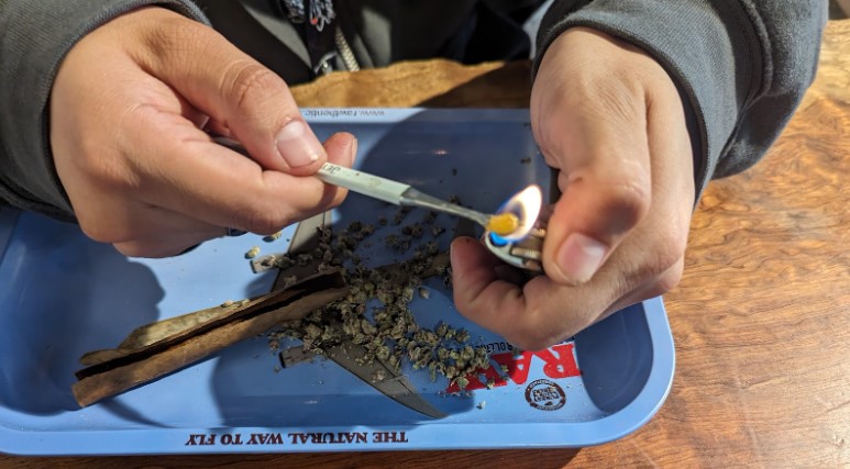 Image of heating up a dab tool to spread cannabis concentrate